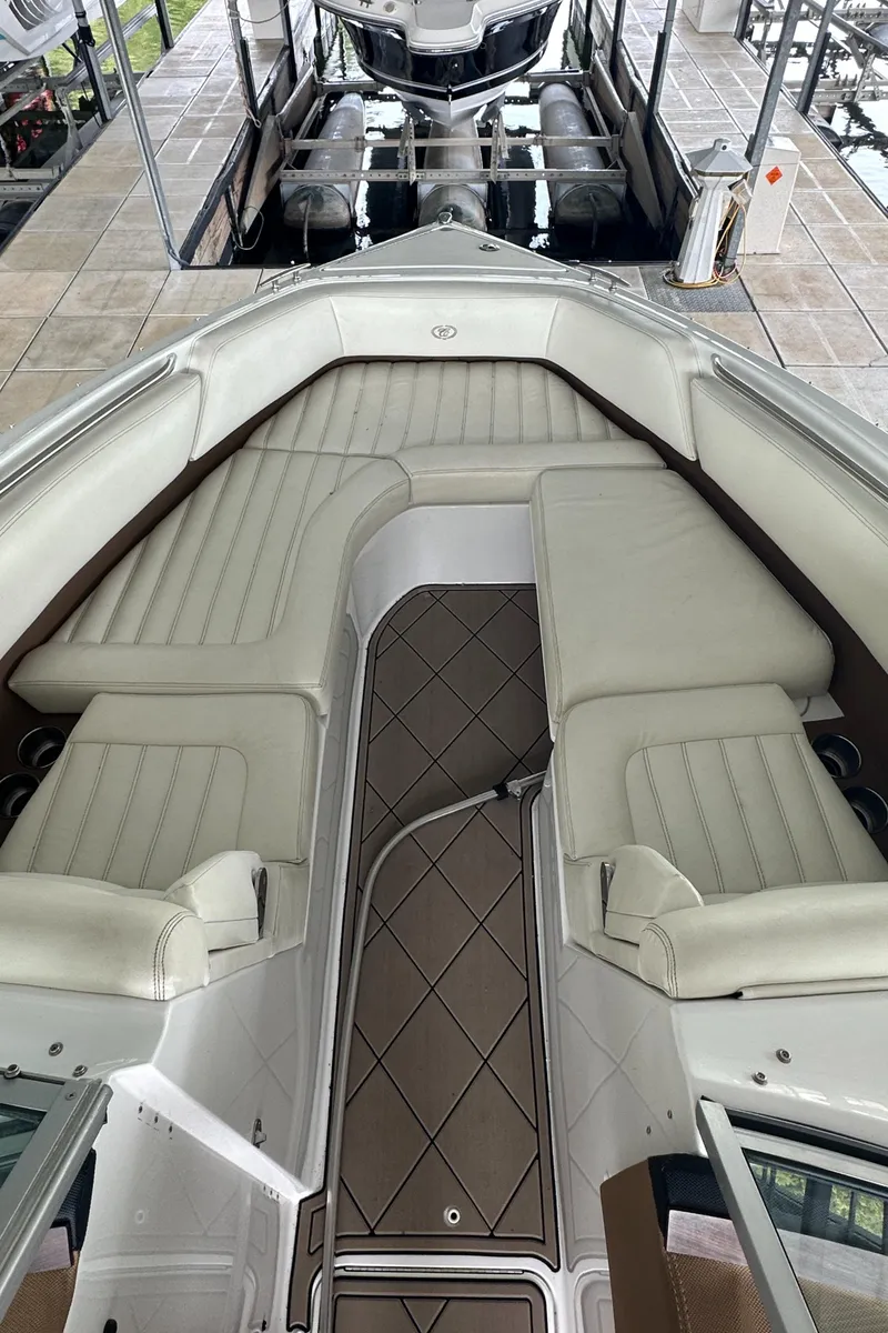 Slide: The Image of 2015 Cobalt R7 boat interior with white leather seating and brown flooring. - 11