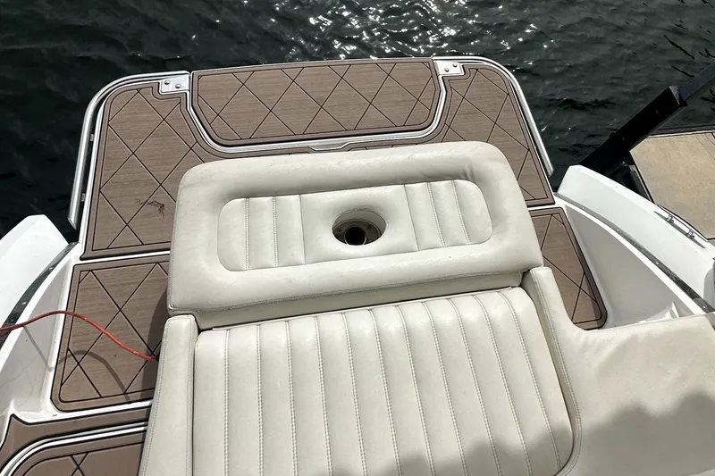 Slide: The Image of 2015 Cobalt R7 boat with cushioned deck, docked by the water. - 16