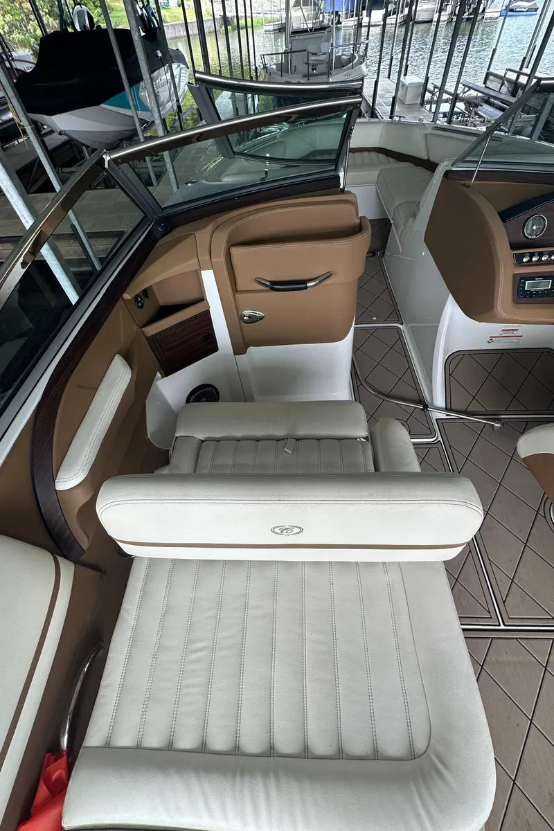 Slide: The Image of 2015 Cobalt R7 boat interior with white leather seating and brown accents. - 20