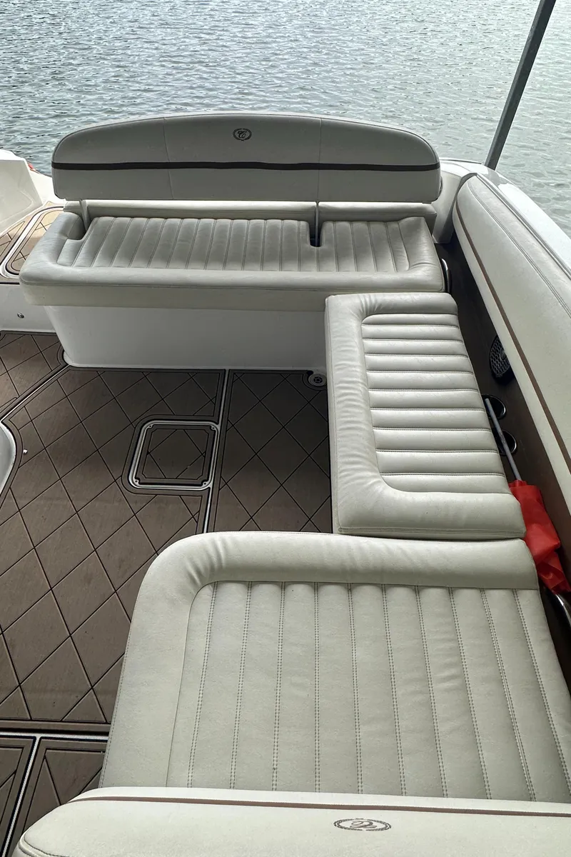 Slide: The Image of 2015 Cobalt R7 boat interior with white cushioned seating and water view. - 23