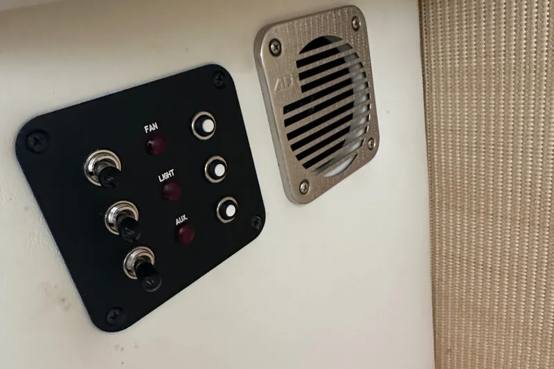 Slide: The Image of Control panel and speaker on 2015 Cobalt R7 boat interior. - 24