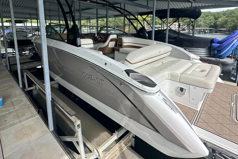 Slide: The Image of 2015 Cobalt R7 boat docked, featuring sleek design and spacious seating. - 4
