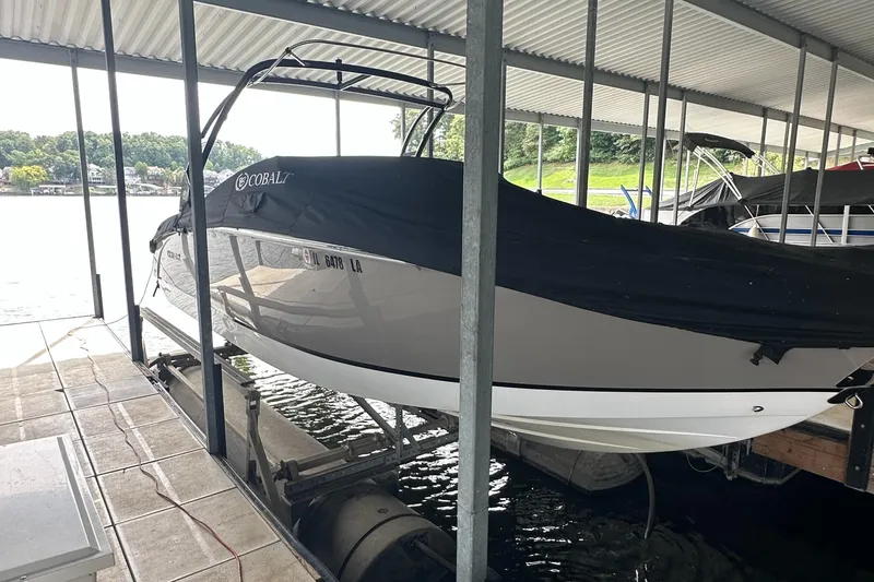 Slide: The Image of 2015 Cobalt R7 boat docked under a covered marina. - 6