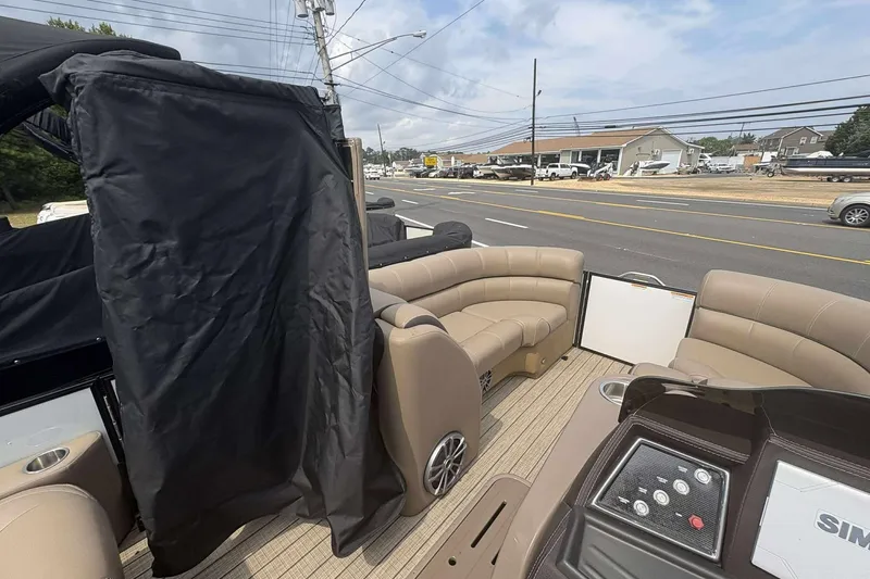 Slide: The Image of 2023 Veranda VTX22RC pontoon boat interior with beige seating and control panel. - 14