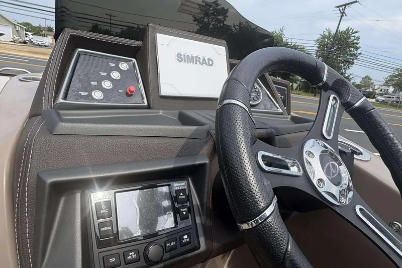 Slide: The Image of 2023 Veranda VTX22RC dashboard with Simrad display and steering wheel. - 19