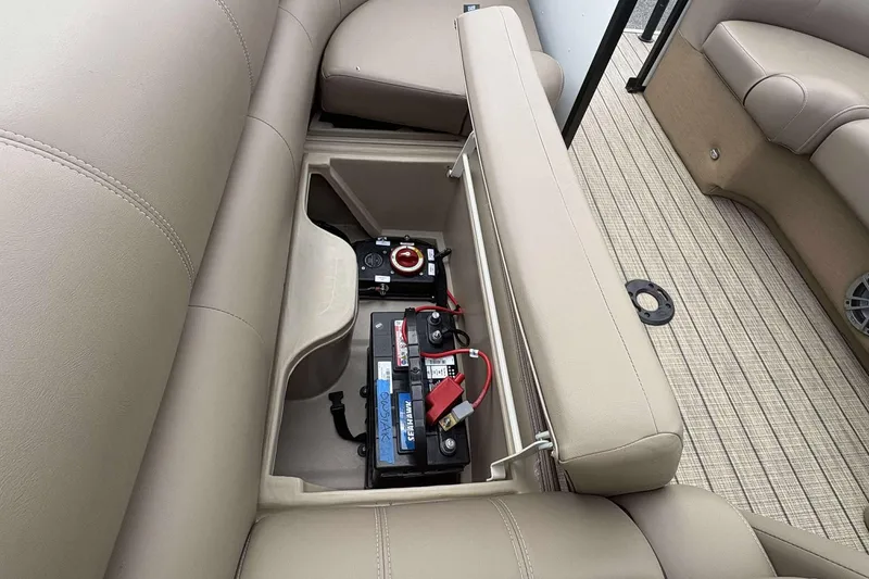 Slide: The Image of 2023 Veranda VTX22RC boat battery compartment with beige seating and flooring. - 20