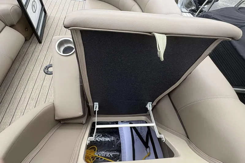 Slide: The Image of 2023 Veranda VTX22RC boat seat storage compartment with cup holder and beige upholstery. - 21