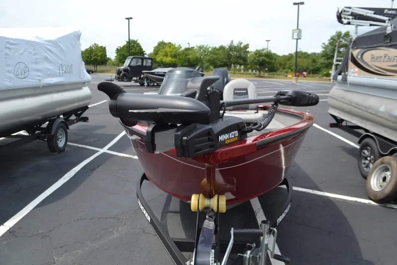 Slide: The Image of 2019 Tracker Super Guide V16 boat with Minn Kota motor in parking lot. - 6