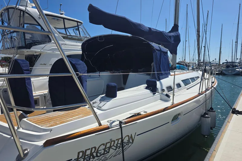 Slide: The Image of 2007 Jeanneau 49 Performance sailboat docked at marina under clear blue sky. - 10
