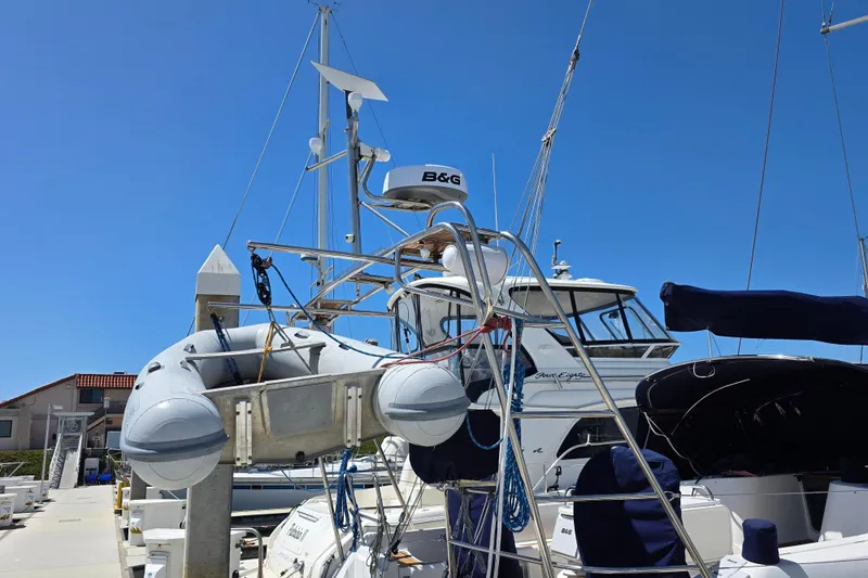 Slide: The Image of 2007 Jeanneau 49 Performance sailboat docked with inflatable dinghy and radar equipment. - 13