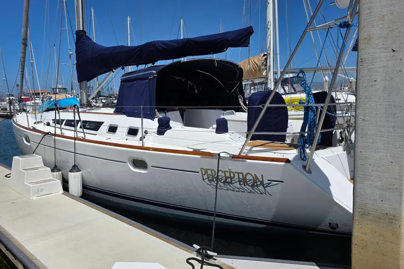 Slide: The Image of 2007 Jeanneau 49 Performance sailboat docked at marina under clear blue sky. - 2
