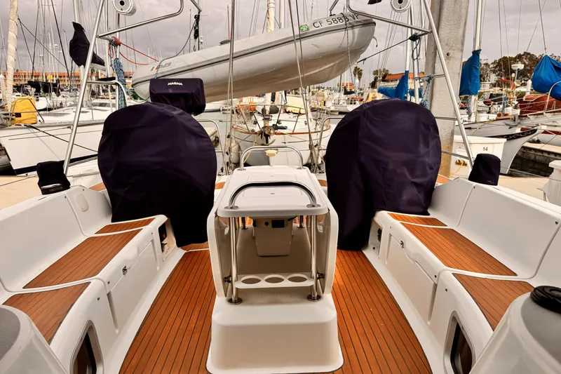 Slide: The Image of 2007 Jeanneau Sun Odyssey 49 Performance sailboat cockpit with covered equipment and wooden deck. - 24