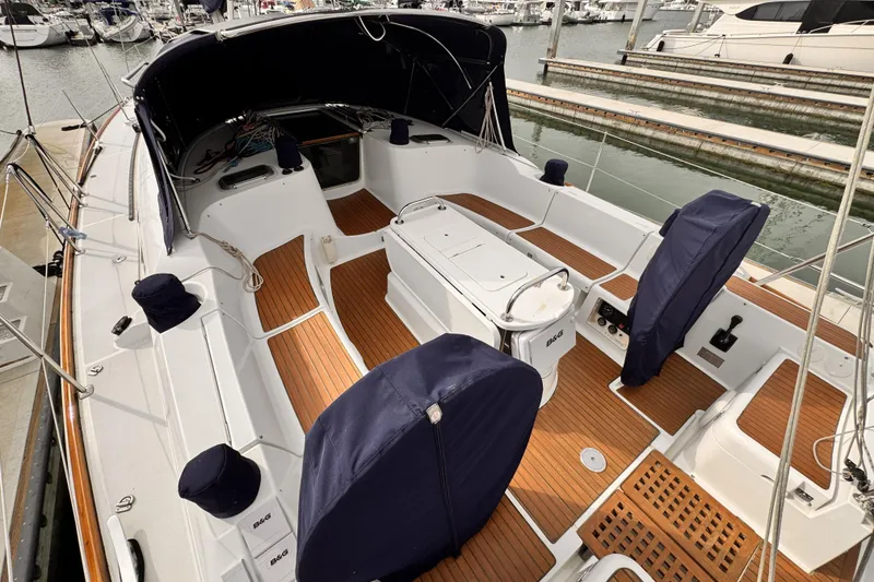 Slide: The Image of 2007 Jeanneau Sun Odyssey 49 Performance sailboat cockpit with teak flooring and covered seating. - 25