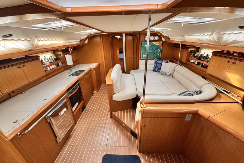 Slide: The Image of Luxurious interior of 2007 Jeanneau Sun Odyssey 49 Performance yacht with wood finish and white seating. - 27