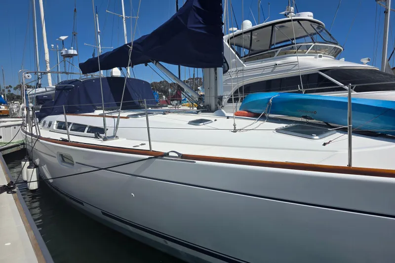 Slide: The Image of 2007 Jeanneau 49 Performance sailboat docked at marina under clear blue sky. - 3