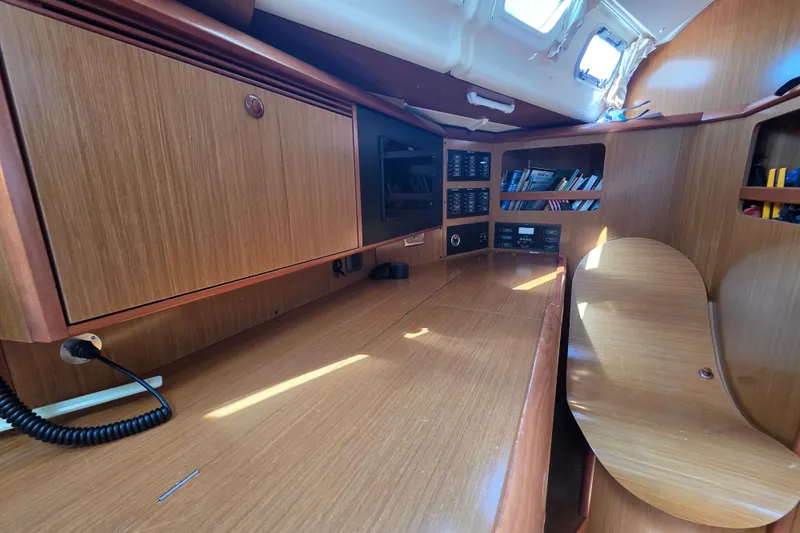 Slide: The Image of 2007 Jeanneau 49 Performance yacht interior with wooden cabinetry and navigation station. - 34