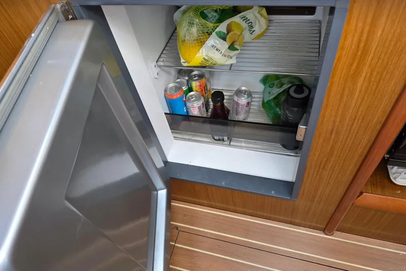 Slide: The Image of Open fridge on 2007 Jeanneau 49 Performance yacht with drinks and lemons inside. - 38