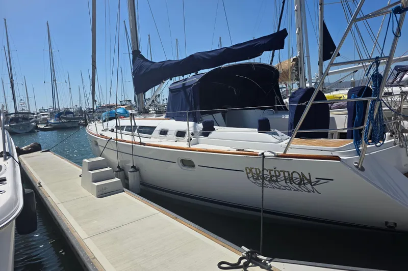 Slide: The Image of 2007 Jeanneau 49 Performance sailboat docked at a marina under clear blue skies. - 4