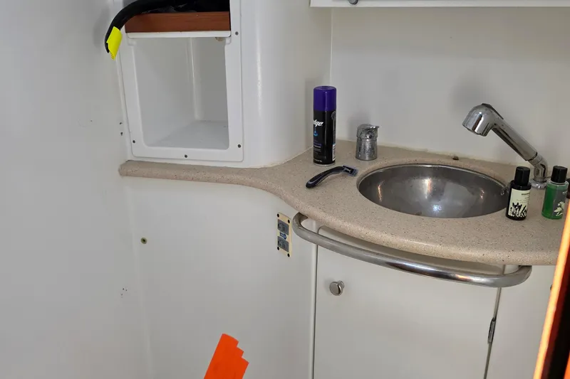 Slide: The Image of Bathroom sink area on a 2007 Jeanneau 49 Performance yacht with toiletries. - 44