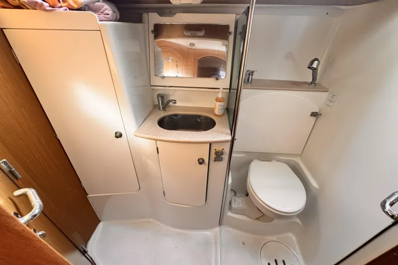 Slide: The Image of 2007 Jeanneau Sun Odyssey 49 Performance yacht bathroom with sink, mirror, and toilet. - 49