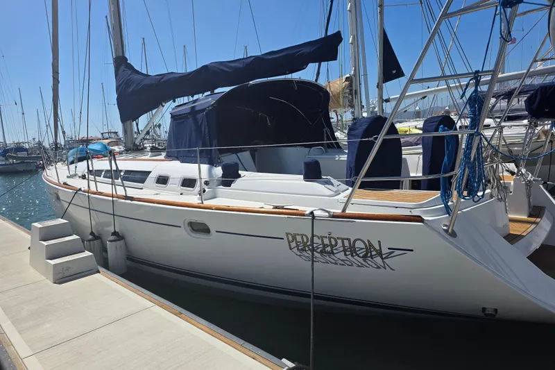 Slide: The Image of 2007 Jeanneau 49 Performance sailboat docked at marina under clear blue sky. - 5