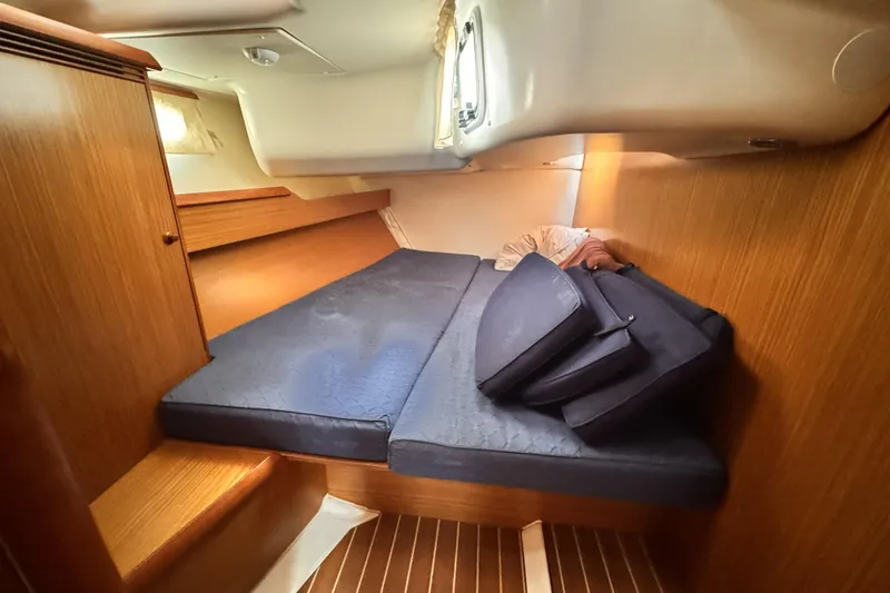 Slide: The Image of 2007 Jeanneau Sun Odyssey 49 Performance cabin with blue cushions and wooden interior. - 51