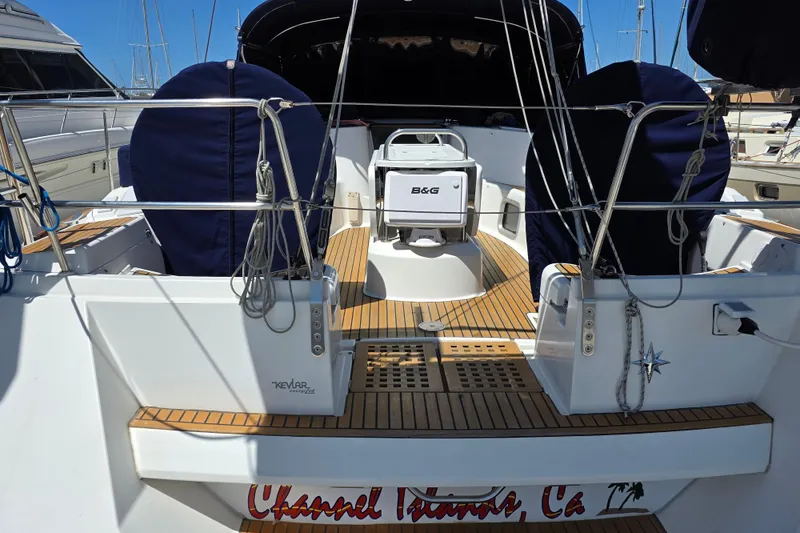 Slide: The Image of 2007 Jeanneau 49 Performance sailboat cockpit with teak flooring and covered seating. - 6