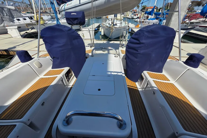 Slide: The Image of 2007 Jeanneau 49 Performance yacht cockpit with covered steering wheels and teak flooring. - 7