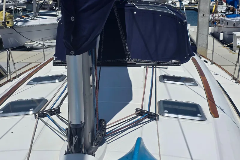 Slide: The Image of 2007 Jeanneau 49 Performance sailboat deck with rigging and hatches in marina. - 8