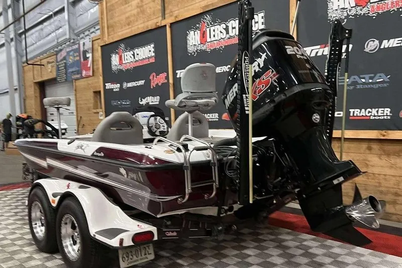 Slide: The Image of 2016 Bass Cat Pantera II boat with powerful engine on display indoors. - 4