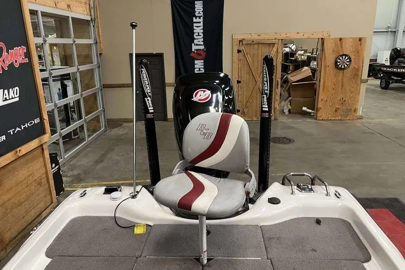 Slide: The Image of 2016 Bass Cat Pantera II boat interior with seat and Power-Pole anchors in a showroom. - 5