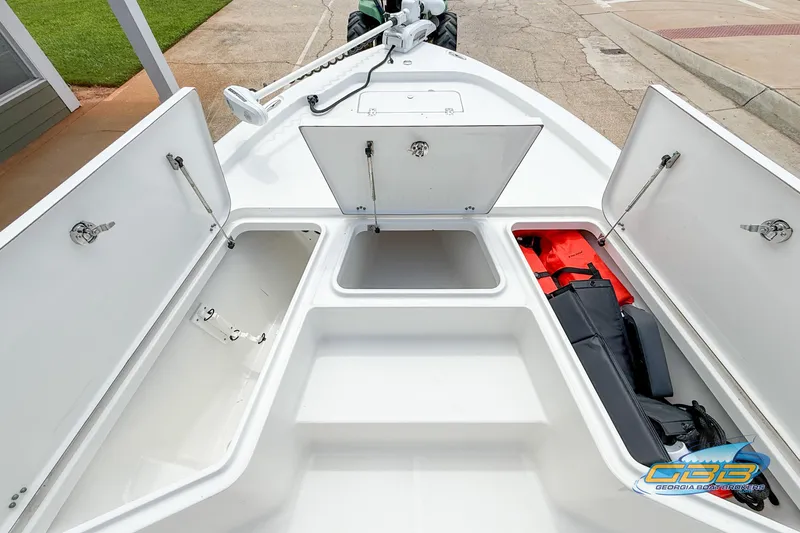 Slide: The Image of 2014 Sea Hunt BX 22 Pro boat storage compartments with safety gear and equipment. - 18