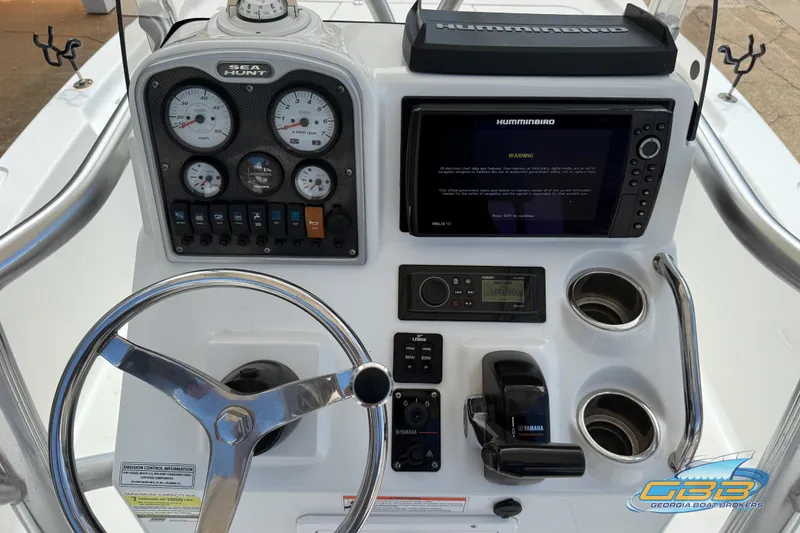 Slide: The Image of 2014 Sea Hunt BX 22 Pro dashboard with steering wheel, gauges, and navigation system. - 20