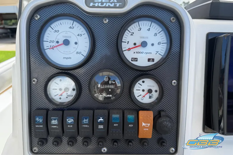 Slide: The Image of 2014 Sea Hunt BX 22 Pro dashboard with Yamaha gauges and control switches. - 21