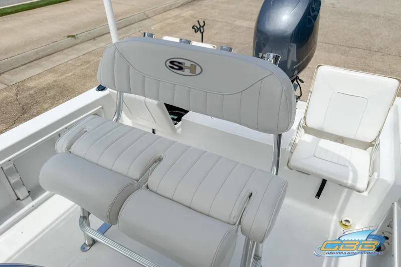 Slide: The Image of 2014 Sea Hunt BX 22 Pro boat interior with cushioned seating and motor. - 26