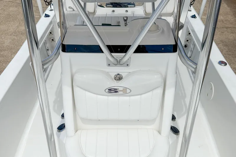 Slide: The Image of 2014 Sea Hunt BX 22 Pro boat interior with white seating and console. - 27