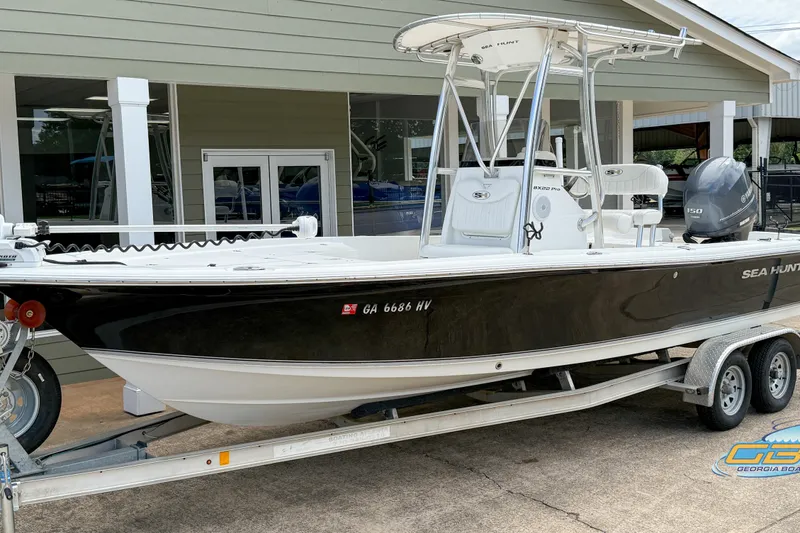 Slide: The Image of 2014 Sea Hunt BX 22 Pro boat on trailer, black and white exterior, parked outside. - 3