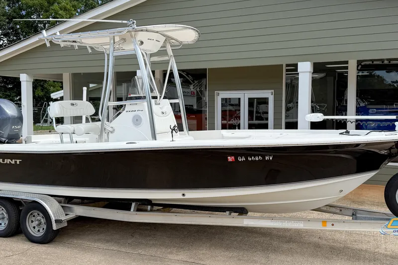 Slide: The Image of 2014 Sea Hunt BX 22 Pro boat on trailer, parked outside a building. - 4