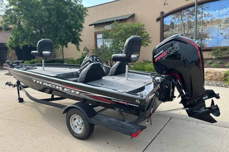 Slide: The Image of 2024 Tracker Pro Team 190 TX boat with Mercury Pro XS engine, parked outdoors. - 2