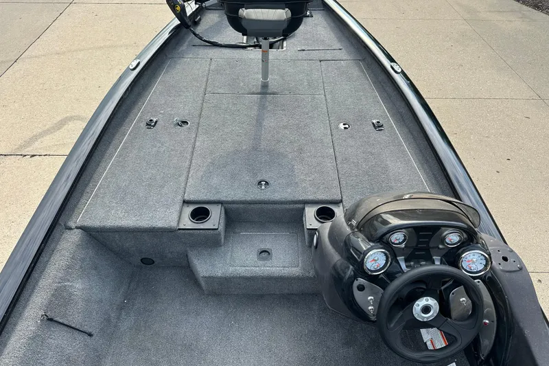 Slide: The Image of 2024 Tracker Pro Team 190 TX boat interior with steering console and seating. - 4