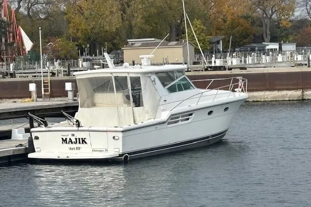 The Image of 2000 Tiara Yachts 4100 Open docked in a marina, rear view. - 0