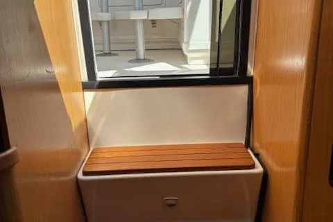 Slide: The Image of 2000 Tiara Yachts 4100 Open interior with wooden bench and window view. - 11