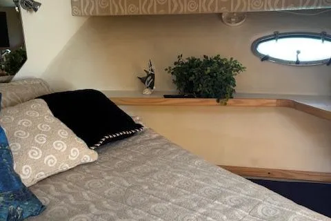 Slide: The Image of Cozy cabin interior of 2000 Tiara Yachts 4100 Open with elegant bedding and decor. - 12