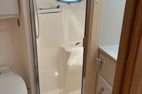 Slide: The Image of 2000 Tiara Yachts 4100 Open bathroom with shower and toilet. - 13