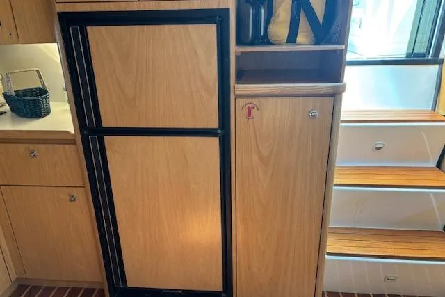 Slide: The Image of 2000 Tiara Yachts 4100 Open interior with wooden cabinetry and steps. - 17