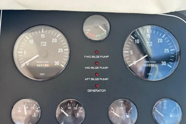 Slide: The Image of Dashboard of a 2000 Tiara Yachts 4100 Open, showing engine gauges and bilge pump indicators. - 18