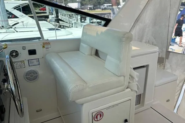 Slide: The Image of 2000 Tiara Yachts 4100 Open docked in a marina under clear skies. - 6