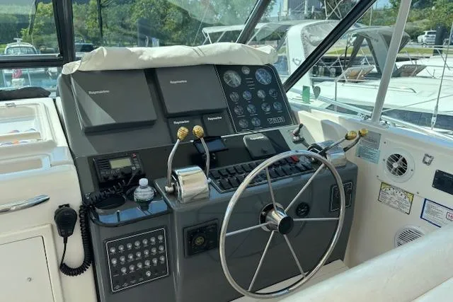 Slide: The Image of Cockpit of 2000 Tiara Yachts 4100 Open with steering wheel and control panel. - 9