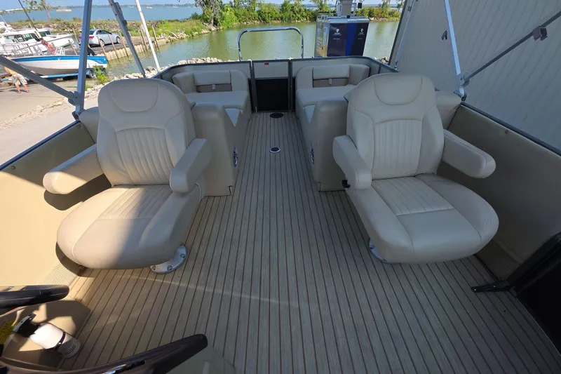 Slide: The Image of 2015 Crest III 230 SL boat interior with beige seating and wood flooring. - 13