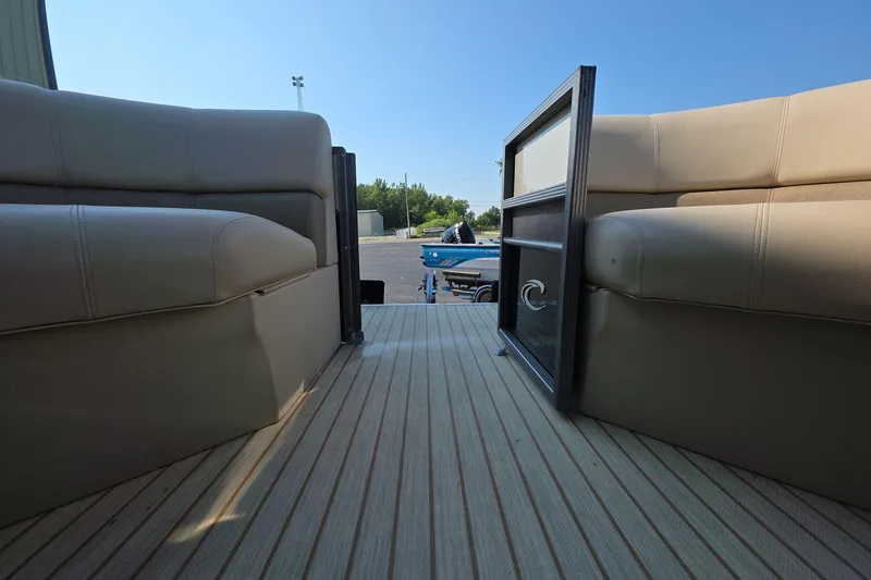 Slide: The Image of Interior view of 2015 Crest III 230 SL pontoon boat with beige seating and open gate. - 18